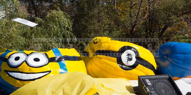 three large pumpkins made into floating boats on display during parade