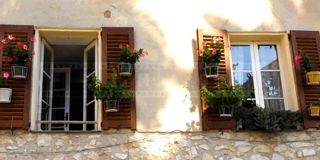 flowers and window shutters in small French town