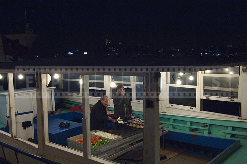 Istanbul waterfront boat grill street food vendor fresh mackerel sandwiches