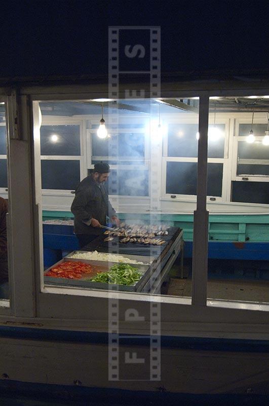 Fresh mackerel grilled on the spot, fisherman, street food vendor