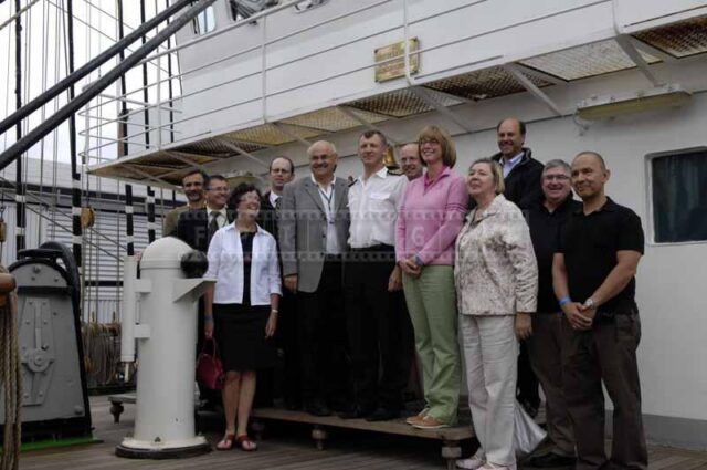 Master posing for a photo with a group of visitors