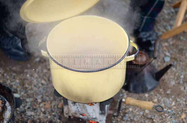 Camp cooker with a steaming pot