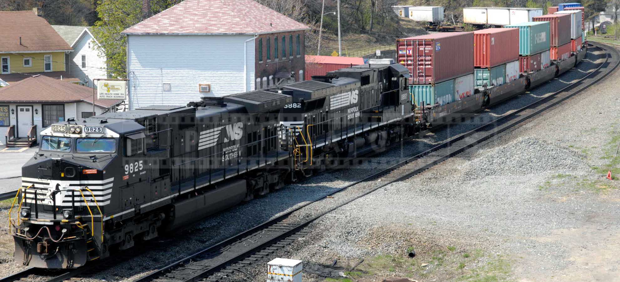 powerful train pulling a load of containers