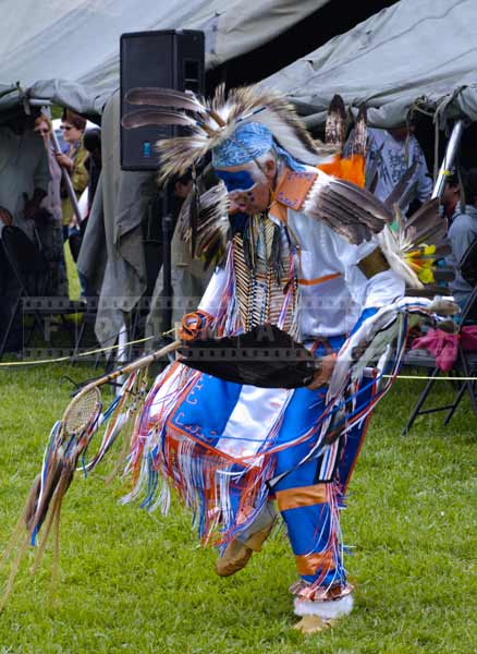 Photo of head dancer doing elaborate fancy dance movements and amazing regalia