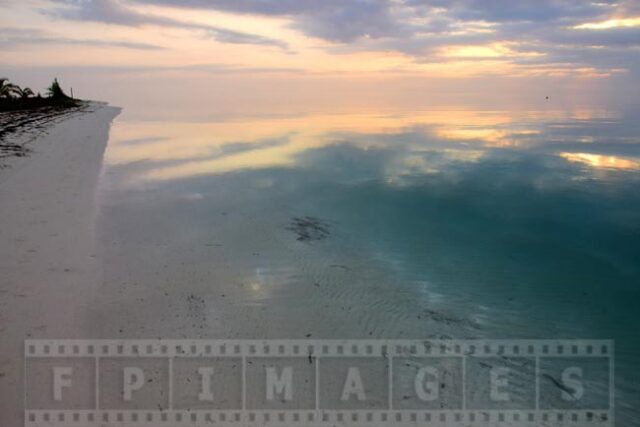 Sky reflections in calm ocean