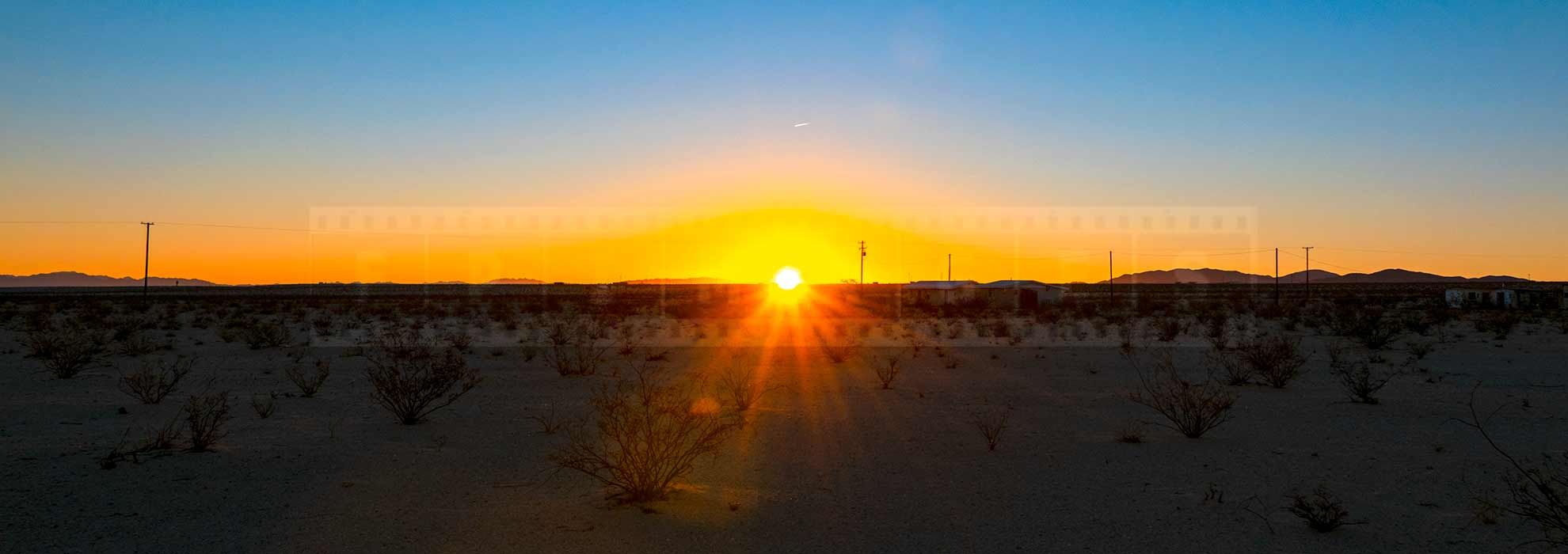 Sun rising above the horizon in the high desert of 29 Palms