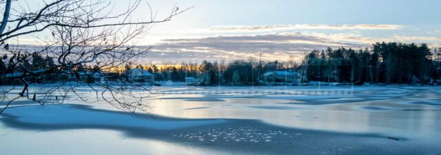 Winter scene - sunrise above frozen lake in Sackville, NS, Canada