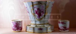 Porcelain cups and a vase with golden accents