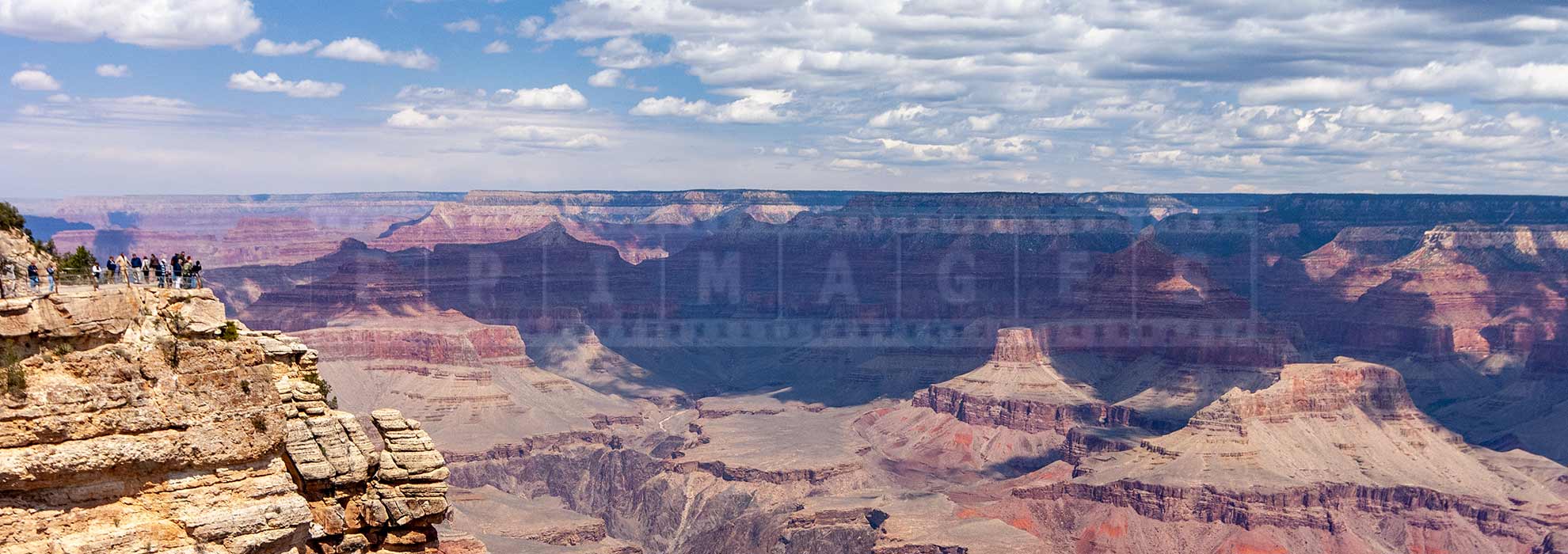 tourists at the lookout point over the Grand Canyon