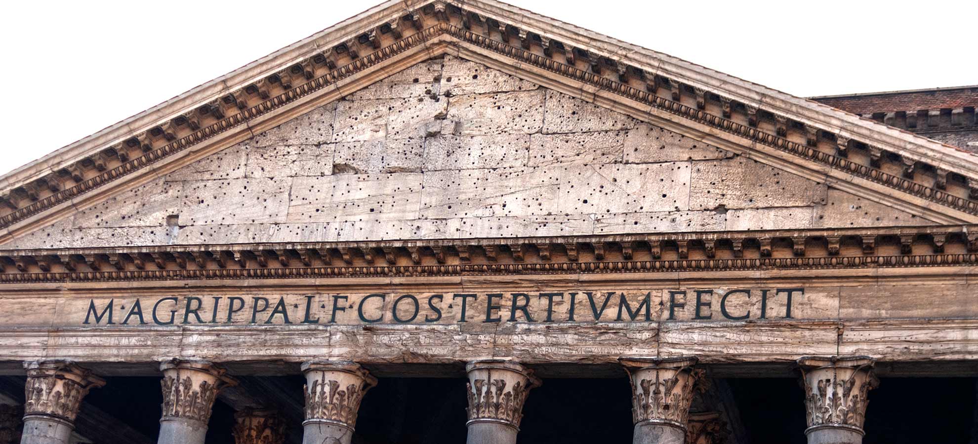 Front of the Pantheon's Portico with a sign saying Marcus Agrippa built this