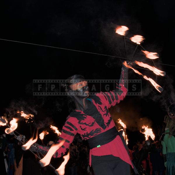 Performer with fire fans at Beltane Fire Festival