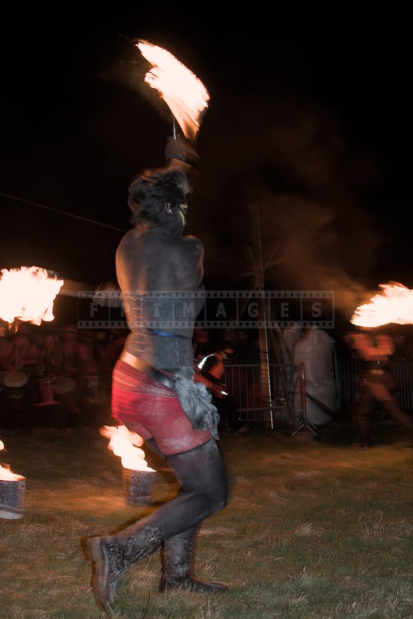 Volunteer doing tricks with fire knives at Beltane fire show