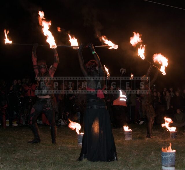 Fire flames rising from fire poles raised by the performers