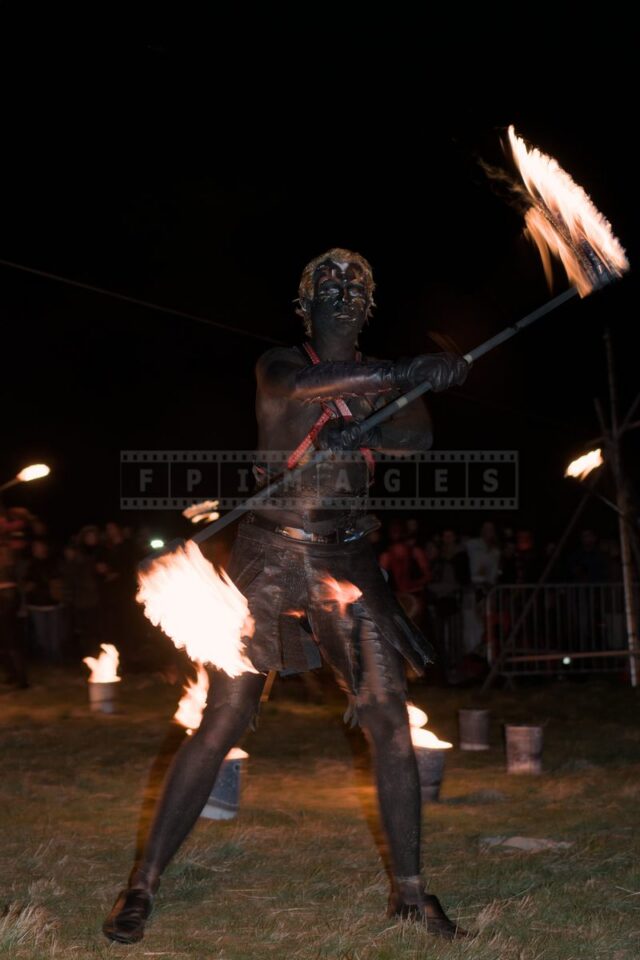fire artist juggling the fire stick called fire staff