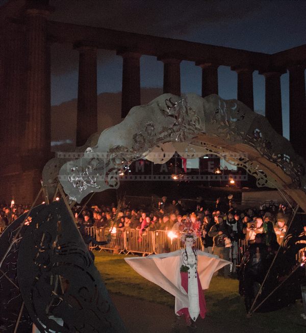 May Queen dancing under the metal arch
