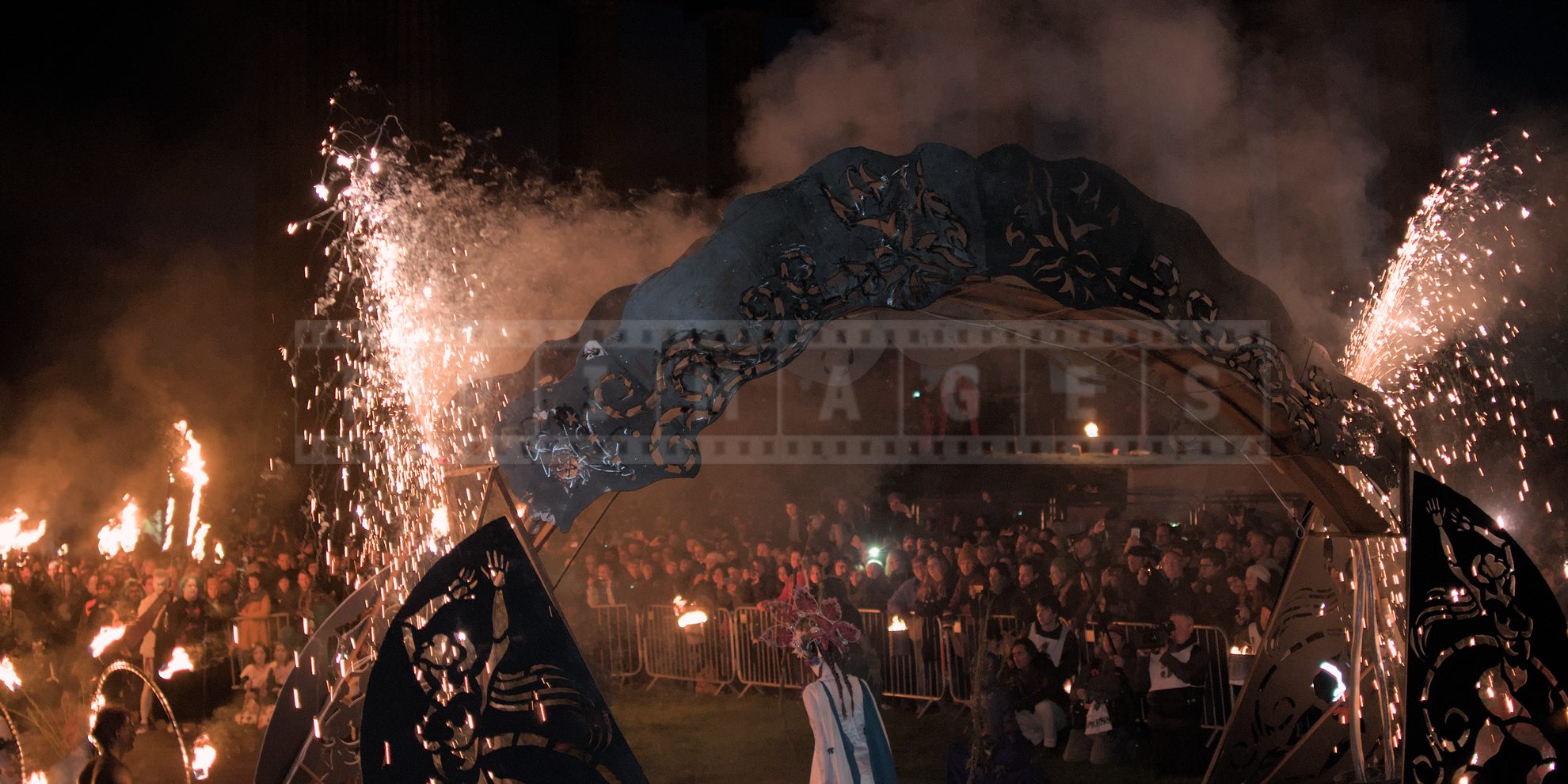 Visitors watching fireworks and fire performance