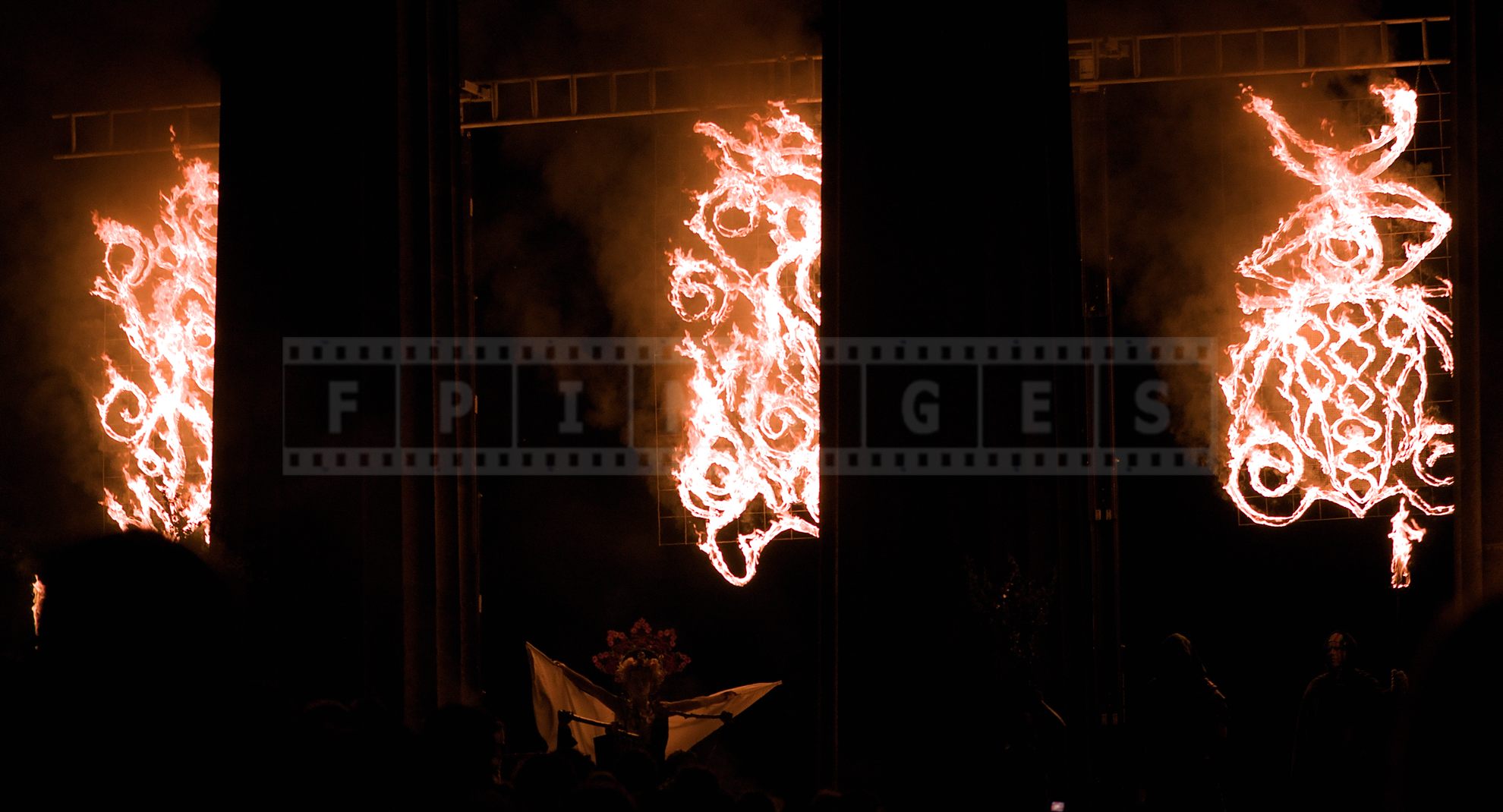 May Queen spreading her arms under the flames at the very start of the festival