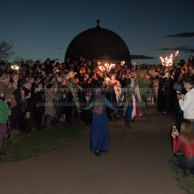 Procession of May Queen and Green man moves between the spectators