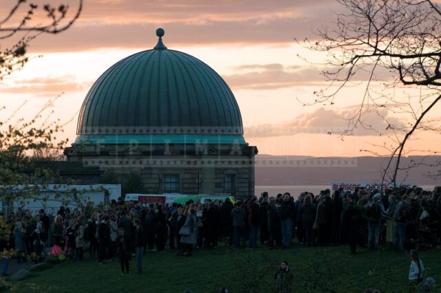 Gorgeous sunset at Calton Hill Observatory and spectators crowd