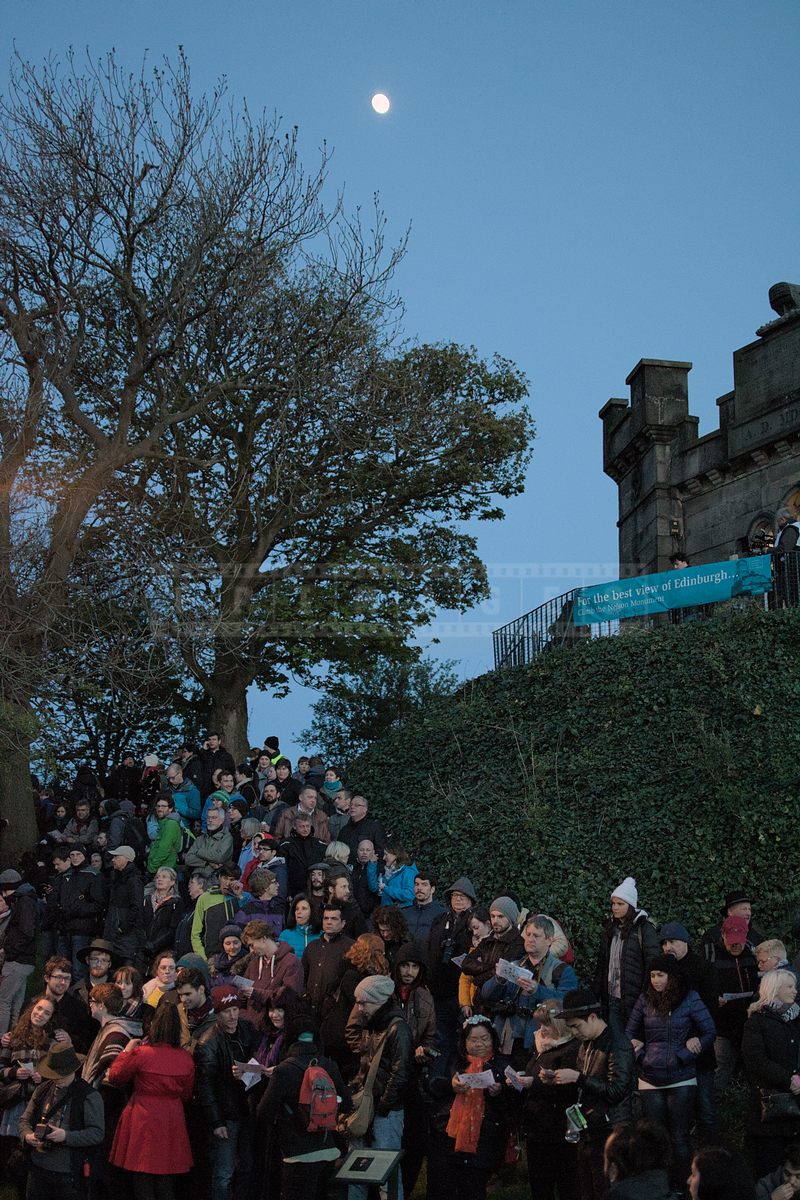 People reading Beltane Fire festival programs and waiting for the show