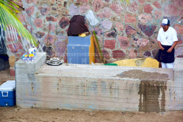 Fresh oysters and Mexican man that prepared them