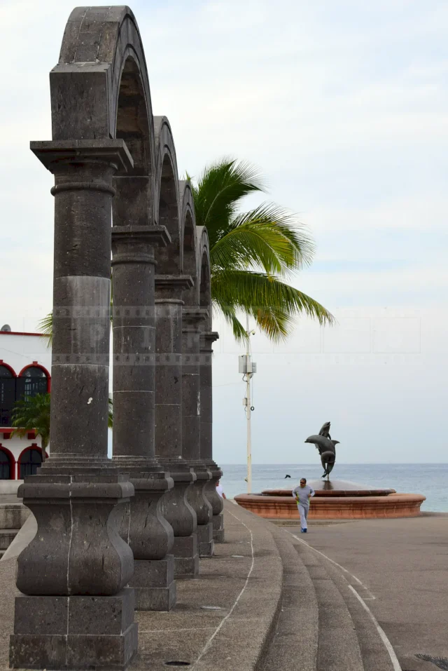person jogging at the waterfront by the statues