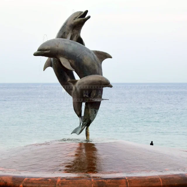 three dolphins playing happily statue